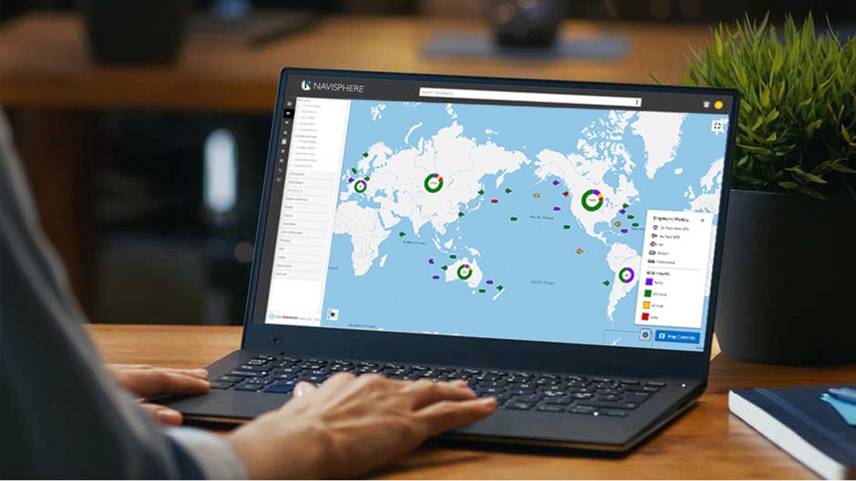 Laptop with screen showing a map of the world
